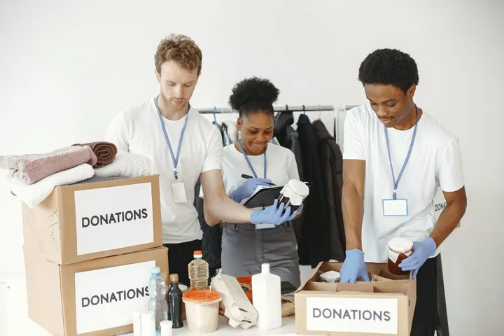 Volunteers sorting donations into labelled boxes