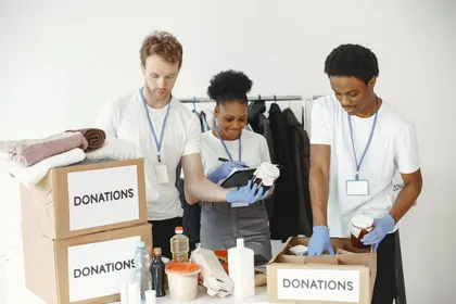 Volunteers sorting donations into labelled boxes