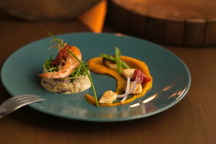 Prawn starter plated on a teal dish